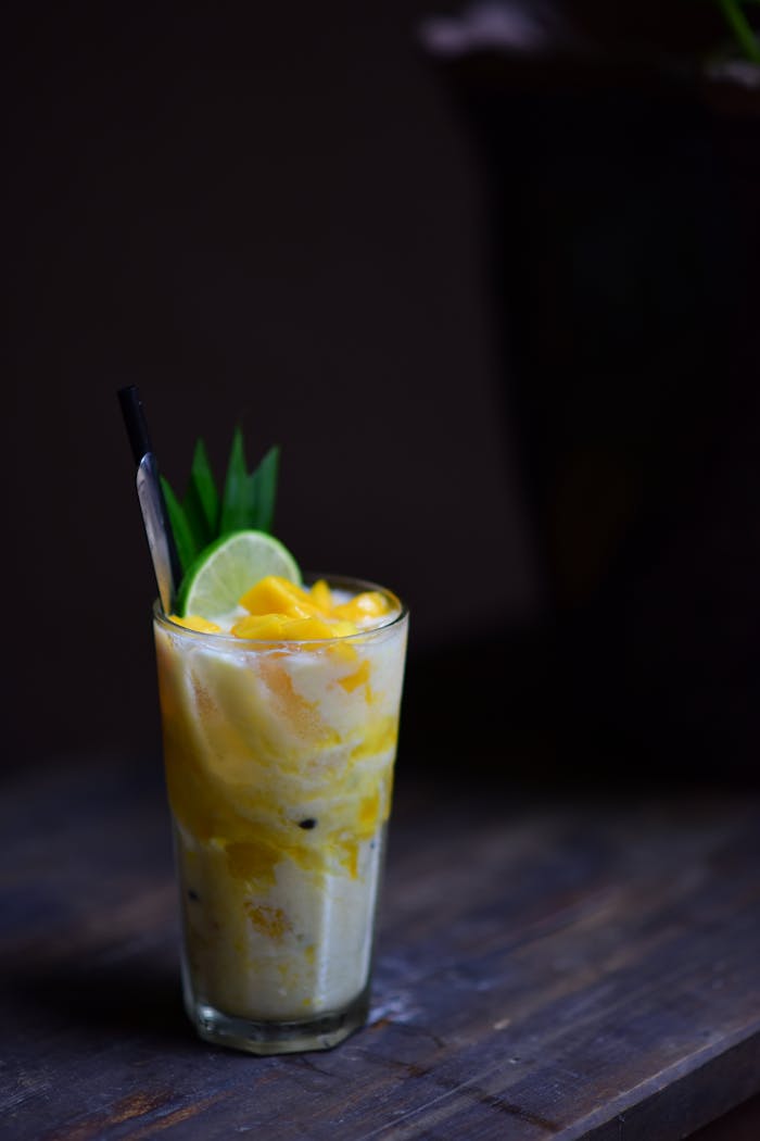 Crafting Captivating Headlines: Your awesome post title goes here Tropical smoothie with mango and lime in a glass on a wooden table, perfect for summer vibes.